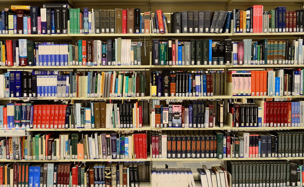 Books and a notebook on a desk