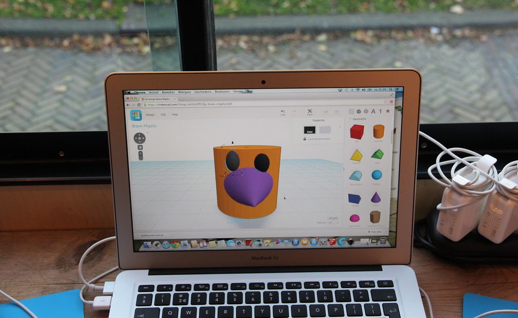An open laptop on a wooden desk