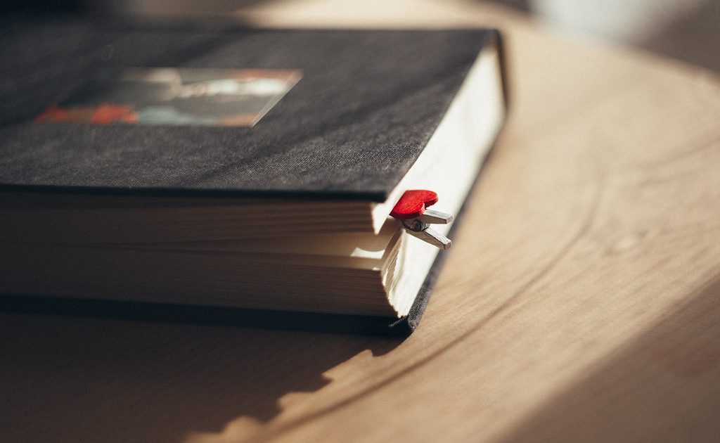 Books and a notebook on a desk