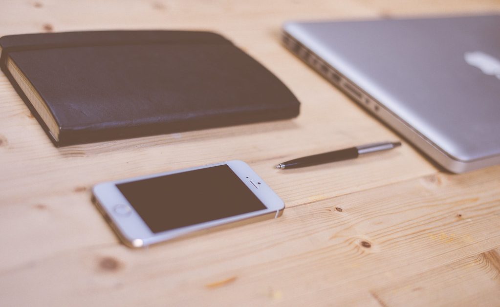 Books and a notebook on a desk