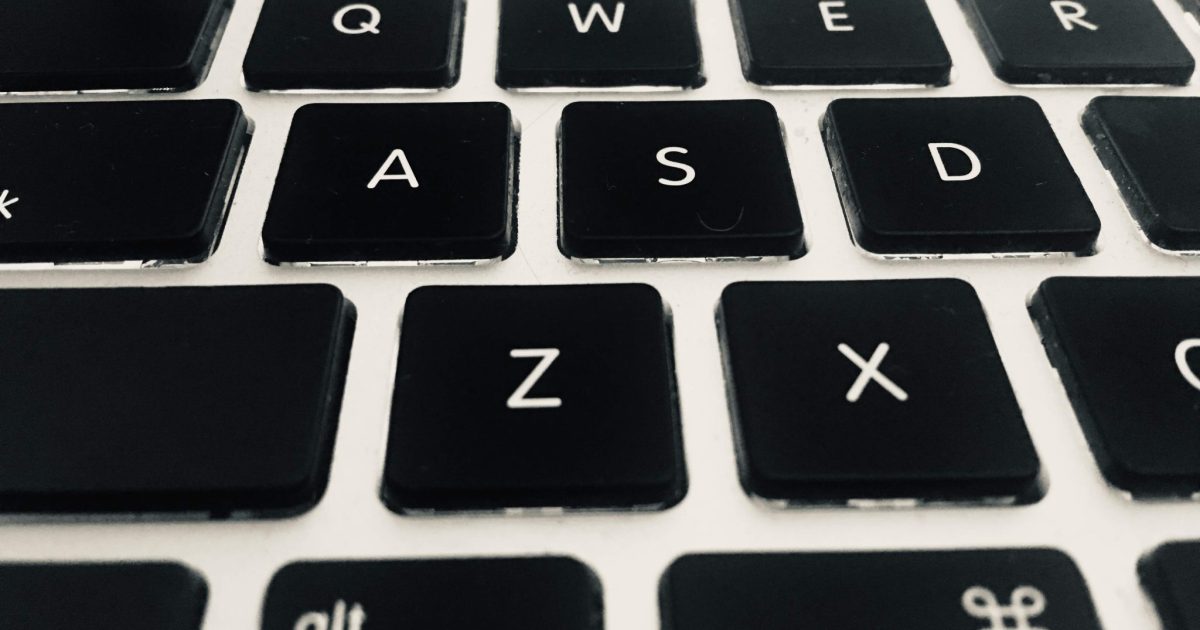 Close-up photograph of a black keyboard with white letters