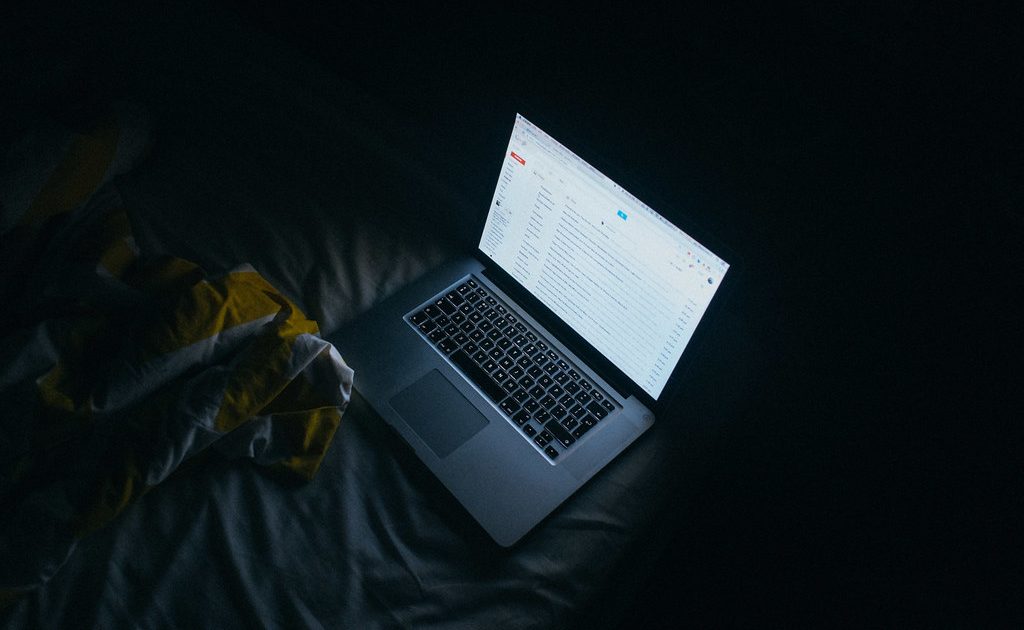 An open laptop on a wooden desk
