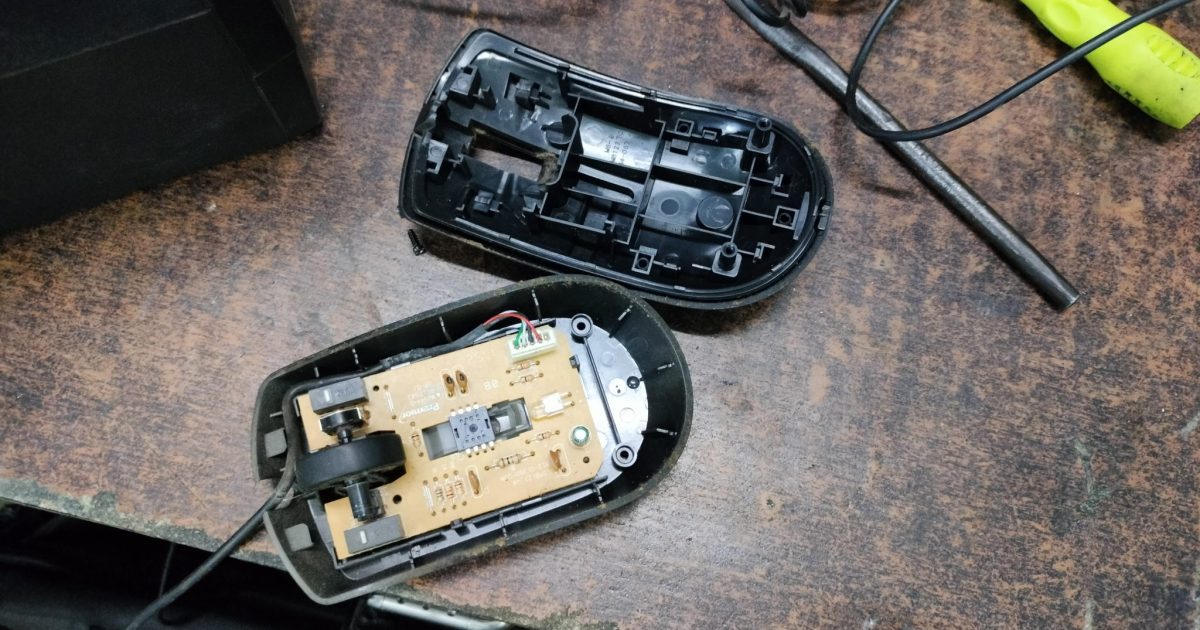 A glimpse inside an opened mouse, showcasing the intricate circuitry that powers our everyday computing