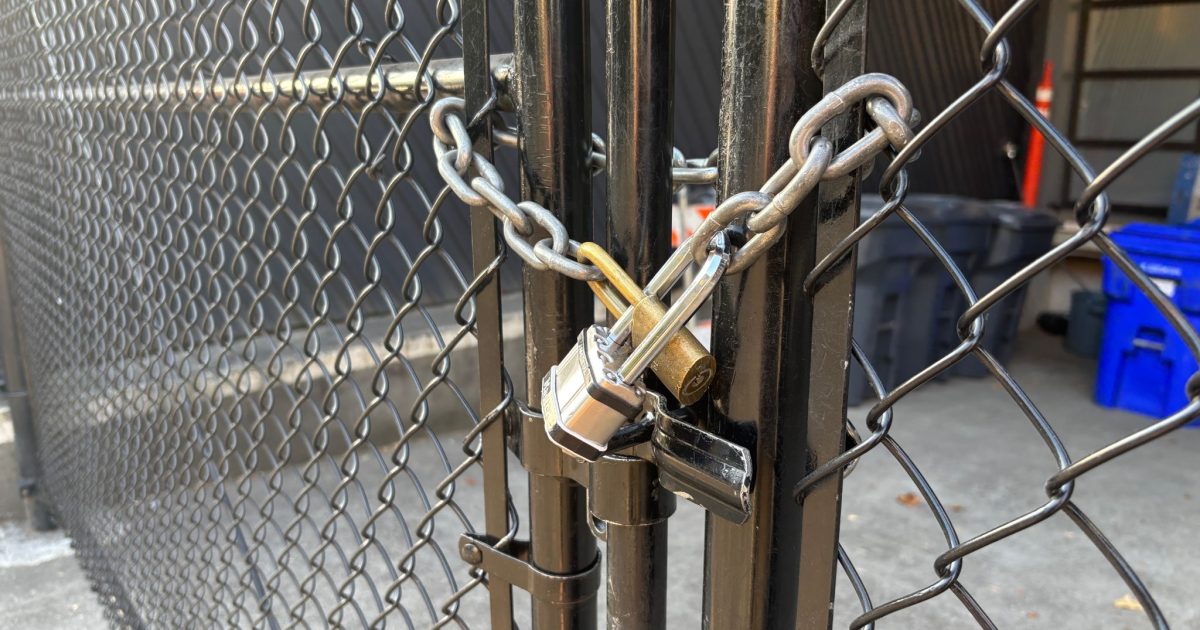 A closeup of the gateway between two fences