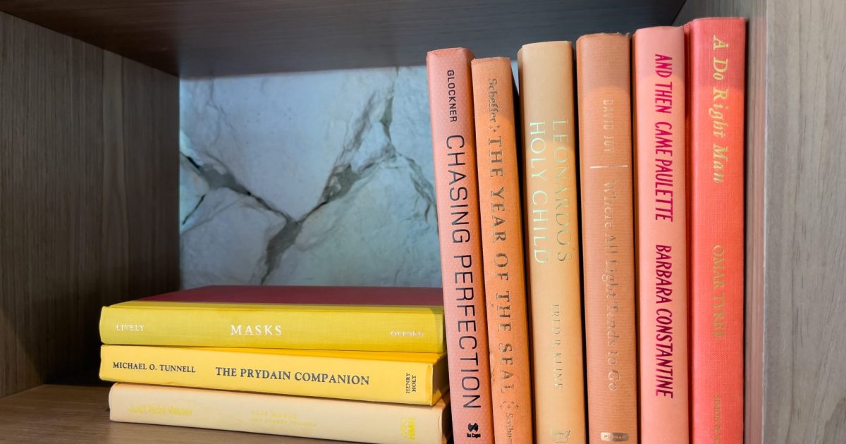 Orange books on a book shelf