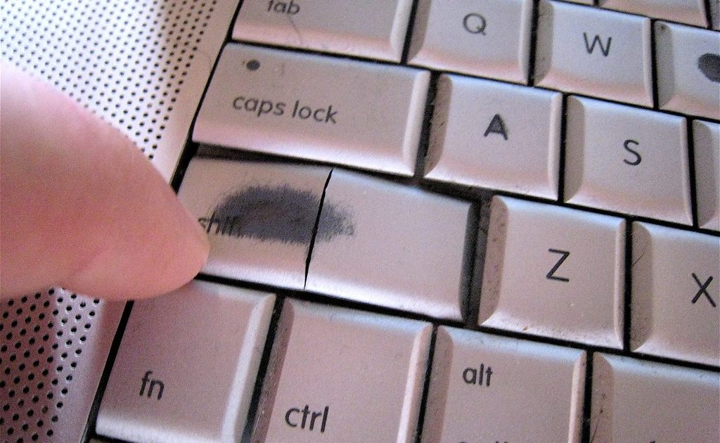 Hands typing on a laptop keyboard