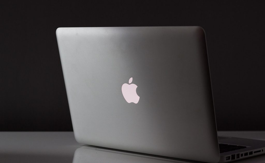 An open laptop on a wooden desk