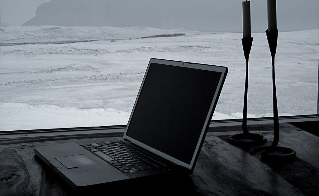 An open laptop on a wooden desk
