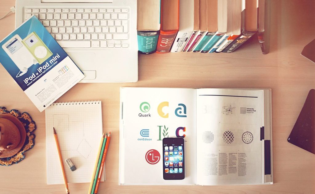 Books and a notebook on a desk