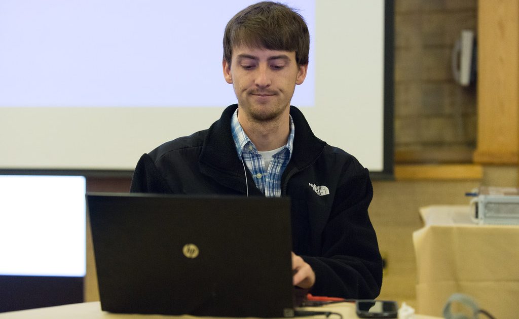 An open laptop on a wooden desk