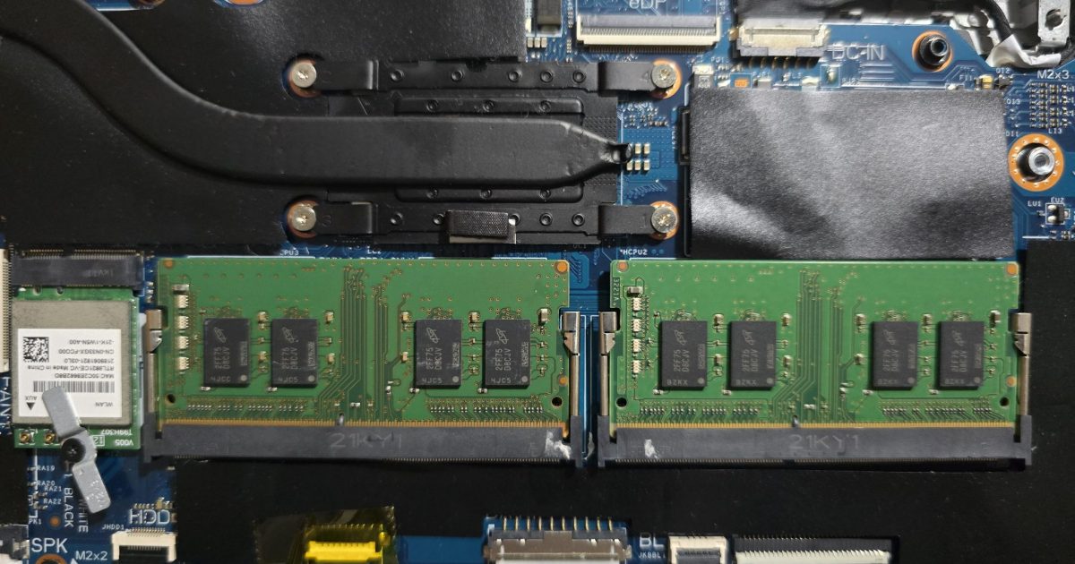 Two SODIMM RAM modules installed on a laptop motherboard with nearby cooling components