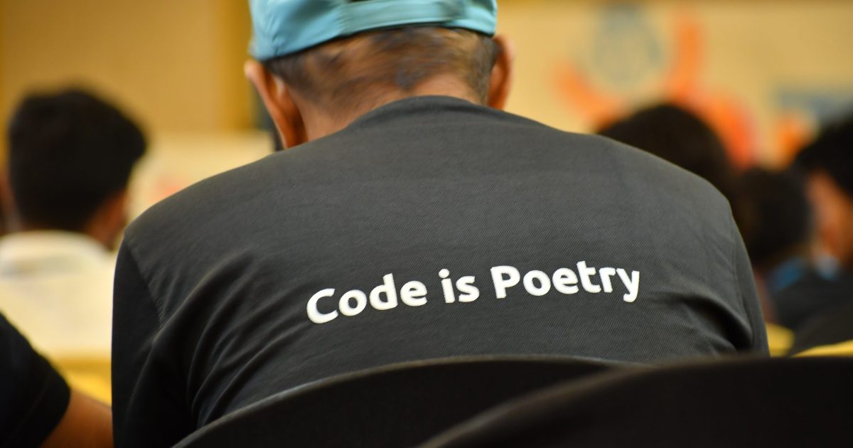 Photo taken from WordPress Youth camp – Wearing T-shirt with WordPress tagline "Code is Poetry"